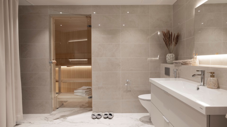 The luxurious bathroom of 76&Piha in a soft style, featuring a light-toned sauna.